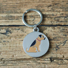 Close-up of Border Terrier dog ID tag — silver-plated brass with illustrated Border Terrier design, personalised dog tag by Sweet William Designs
