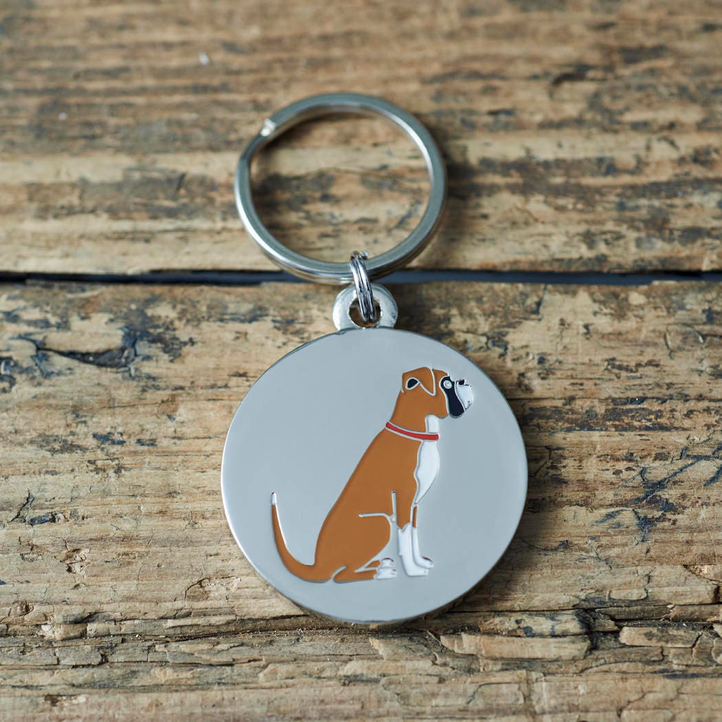 Close-up of Boxer dog ID tag — silver-plated brass with illustrated Boxer design, personalised dog tag by Sweet William Designs
