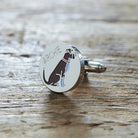 Close-up of personalised Boxer cufflink engraved with name on rustic wood — silver-plated gift for Boxer owners