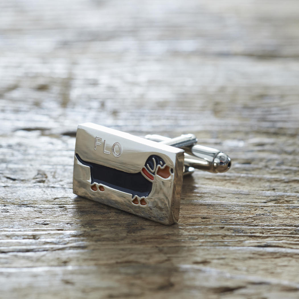 Close-up of personalised Dachshund cufflink engraved with name on rustic wood — silver-plated gift for Dachshund owners