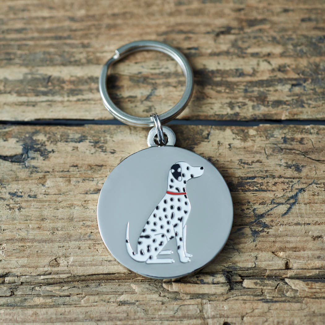 Close-up of Dalmatian dog ID tag — silver-plated brass with illustrated Dalmatian design, personalised dog tag by Sweet William Designs