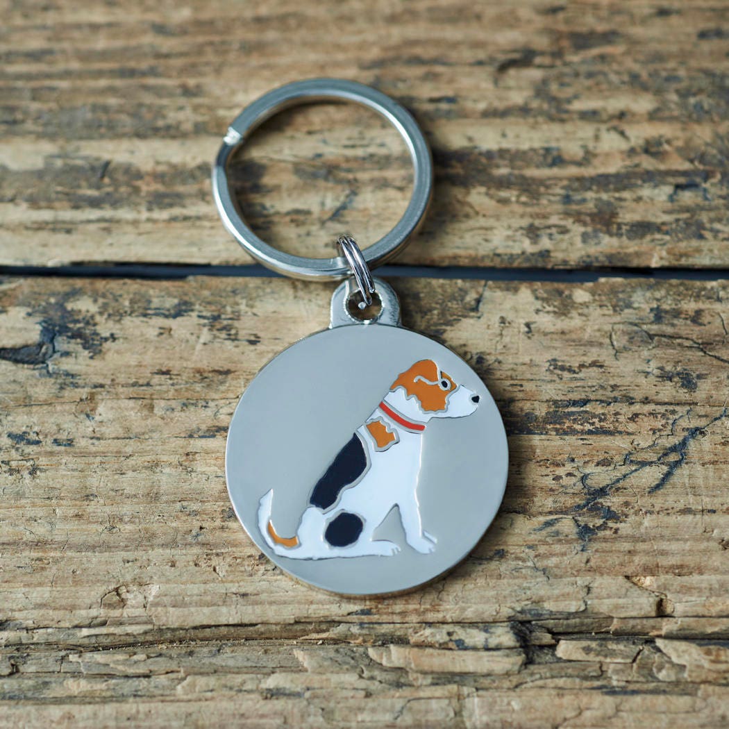 Close-up of Jack Russell dog ID tag — silver-plated brass with illustrated Jack Russell design, personalised dog tag by Sweet William Designs