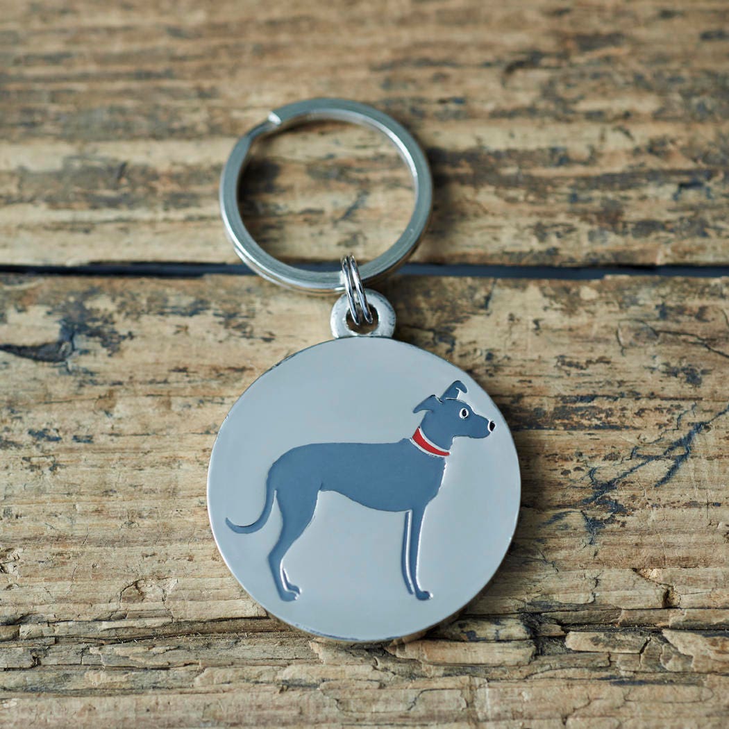 Close-up of Lurcher dog ID tag — silver-plated brass with illustrated Lurcher design, personalised dog tag by Sweet William Designs