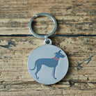 Close-up of Lurcher dog ID tag — silver-plated brass with illustrated Lurcher design, personalised dog tag by Sweet William Designs