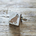 Close-up of personalised Pug cufflink engraved with name on rustic wood — silver-plated gift for Pug owners