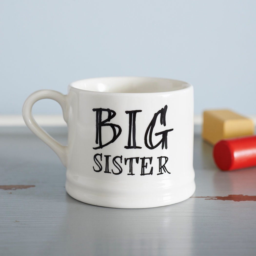 Ceramic “Big Sister” mug photographed beside colourful crayons as a lovely gift for a big sister
