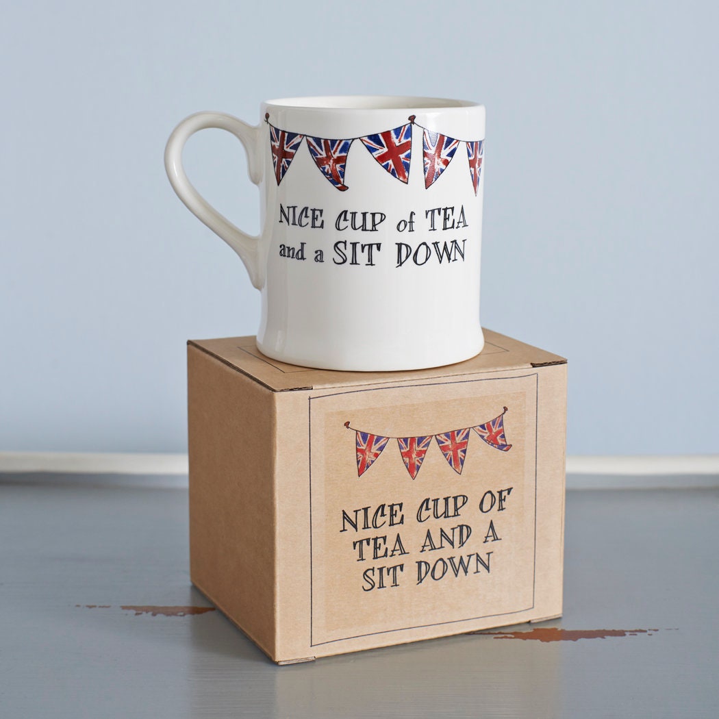 Ceramic mug with Union Jack bunting and a “Nice cup of tea and a sit down” message displayed on its gift box, a perfect gift for tea lovers