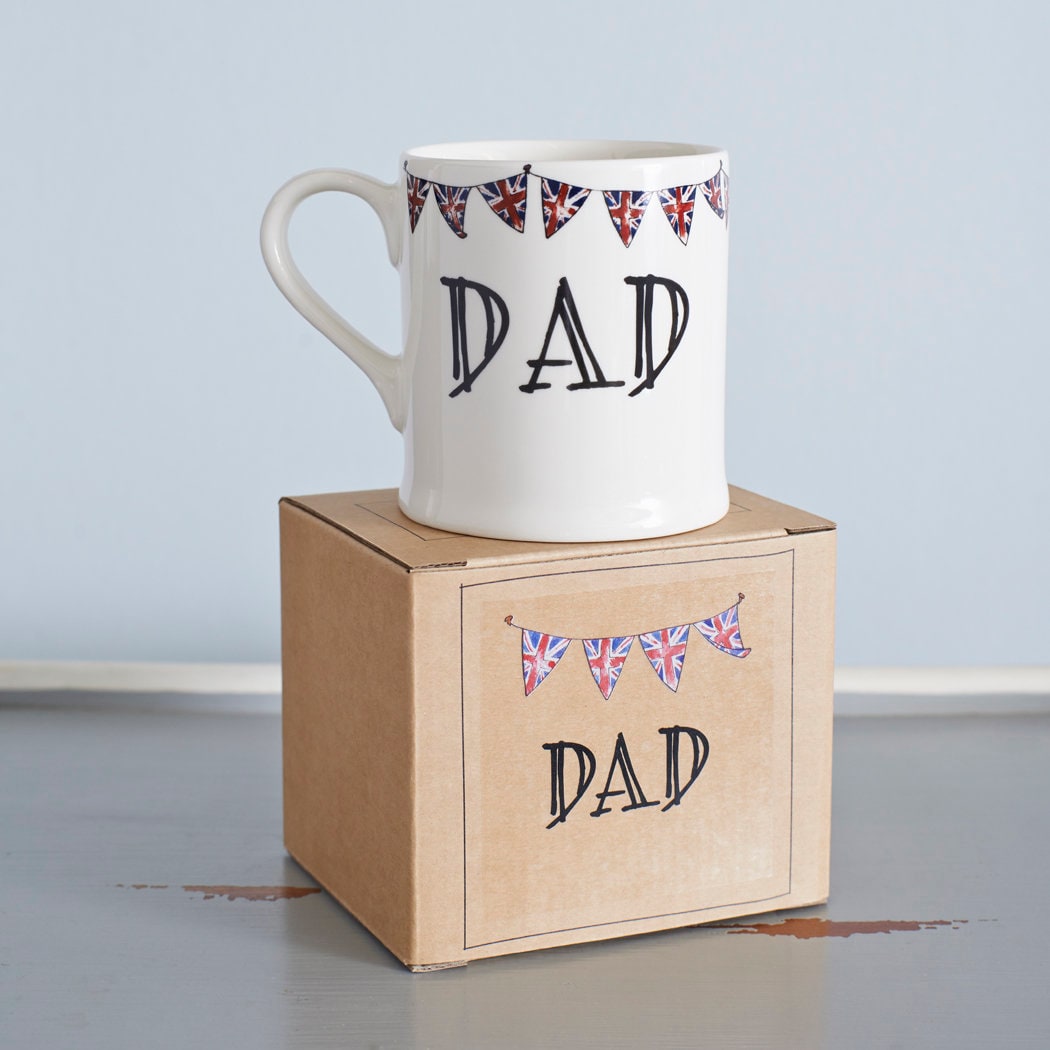 Ceramic Dad mug with hand-drawn Union Jack bunting, displayed on a kraft gift box for easy gifting