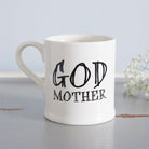 Ceramic Godmother mug styled with delicate white flowers, a thoughtful godparent gift from Sweet William Designs