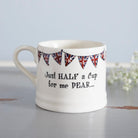 Porcelain half-cup mug with Union Jack bunting and the playful message, “Just half a cup for me dear…”
