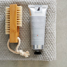 Dog Walkers Revival Hand Cream styled with a small wooden brush, a thoughtful gift for dog walkers by Sweet William Designs