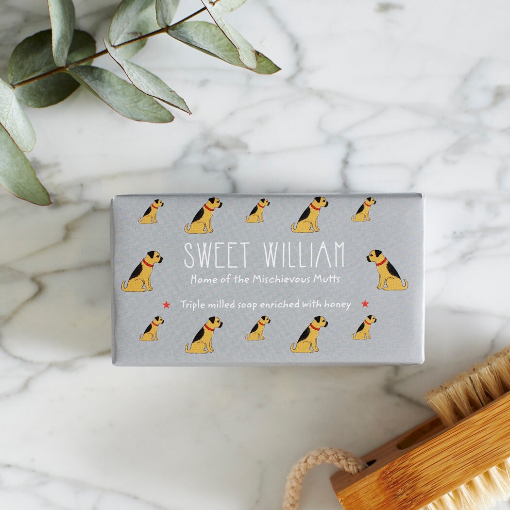 Close-up of Border Terrier soap packaging — Sweet William triple milled soap enriched with honey, illustrated Border Terrier repeat pattern