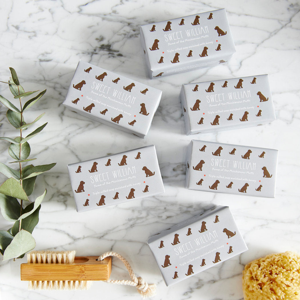 Collection of Chocolate Cockapoo / Labradoodle triple milled soaps on marble surface — honey-enriched luxury dog lover gift by Sweet William Designs