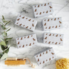 Collection of Chocolate Cockapoo / Labradoodle triple milled soaps on marble surface — honey-enriched luxury dog lover gift by Sweet William Designs