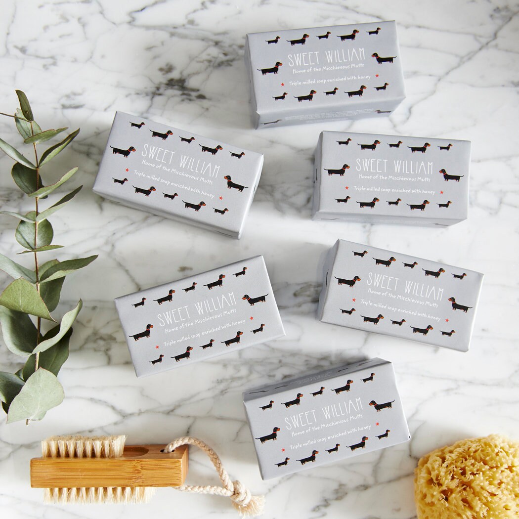 Collection of Dachshund triple milled soaps on marble surface — honey-enriched luxury dog lover gift by Sweet William Designs
