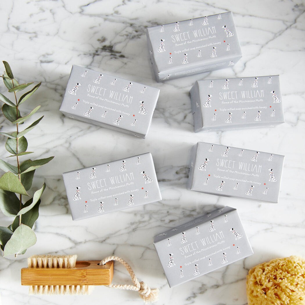 Collection of Dalmatian triple milled soaps on marble surface — honey-enriched luxury dog lover gift by Sweet William Designs