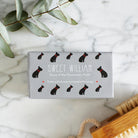 Close-up of French Bulldog soap packaging — Sweet William triple milled soap enriched with honey, illustrated French Bulldog repeat pattern