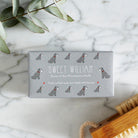 Close-up of Grey Schnauzer soap packaging — Sweet William triple milled soap enriched with honey, featuring an illustrated Grey Schnauzer repeat pattern