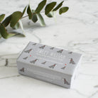 Grey Schnauzer triple milled soap on marble surface — honey-enriched luxury soap in Grey Schnauzer illustrated packaging by Sweet William Designs