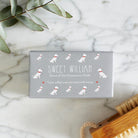 Close-up of Westie soap packaging — Sweet William triple milled soap enriched with honey, illustrated Westie repeat pattern