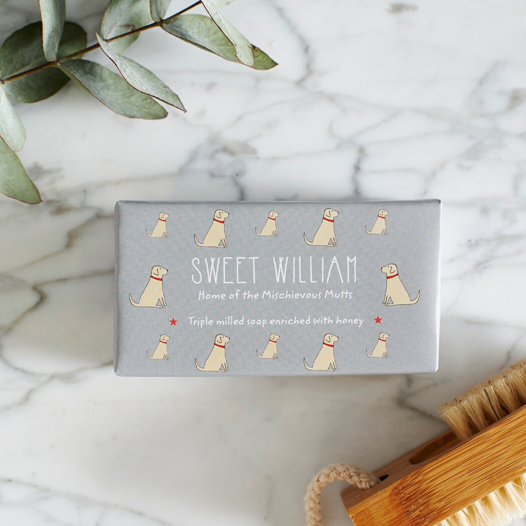 Close-up of Yellow Labrador soap packaging — Sweet William triple milled soap enriched with honey, featuring an illustrated Yellow Labrador repeat pattern