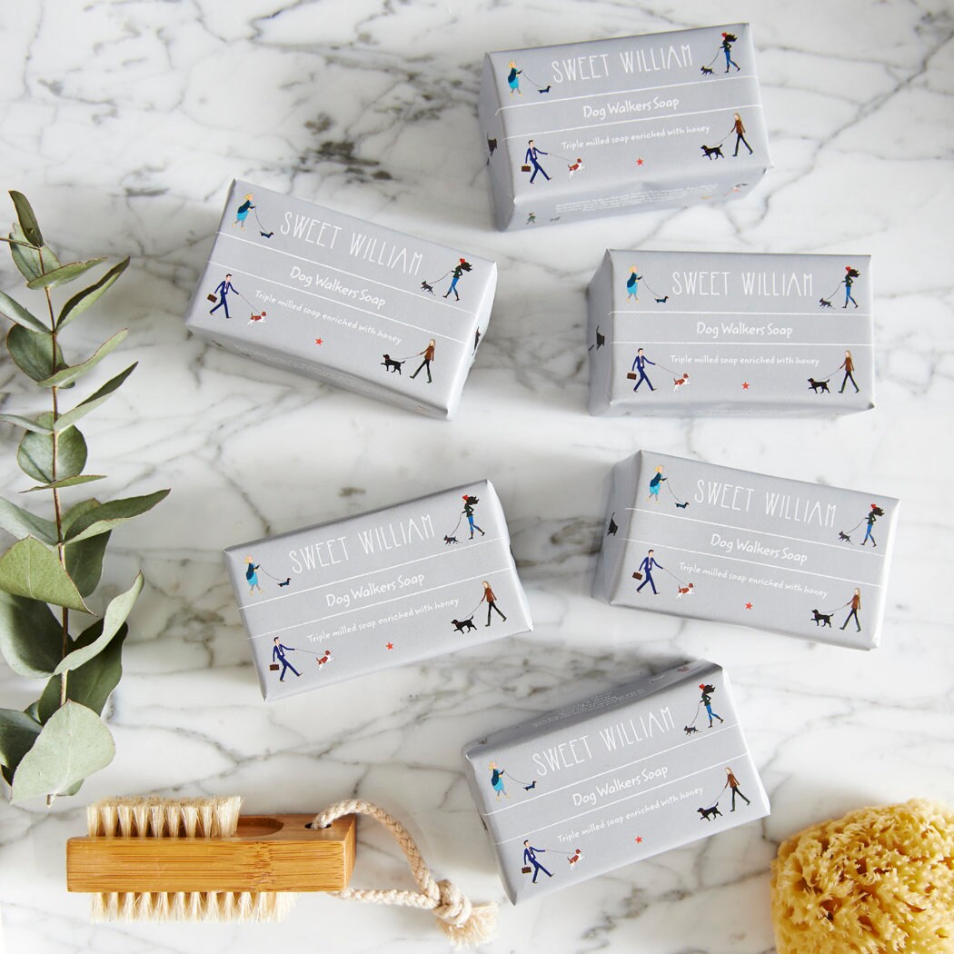 Six bars of Dog Walkers Revival Soap on marble surface with brush and natural sponge — thoughtful gift for dog walkers by Sweet William Designs
