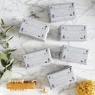 Six bars of Dog Walkers Revival Soap on marble surface with brush and natural sponge — thoughtful gift for dog walkers by Sweet William Designs