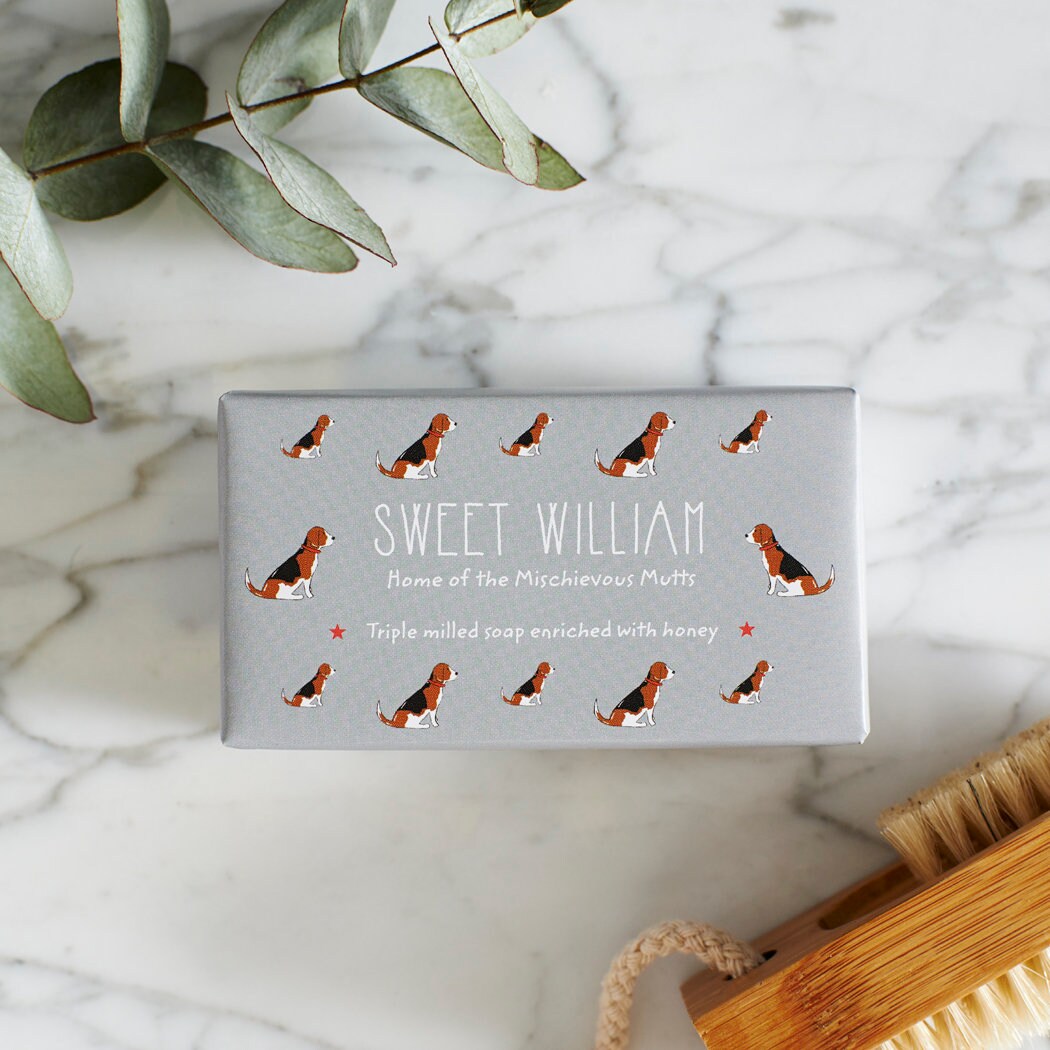 Close-up of Beagle soap packaging — Sweet William triple milled soap enriched with honey, illustrated Beagle repeat pattern