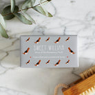 Close-up of Beagle soap packaging — Sweet William triple milled soap enriched with honey, illustrated Beagle repeat pattern