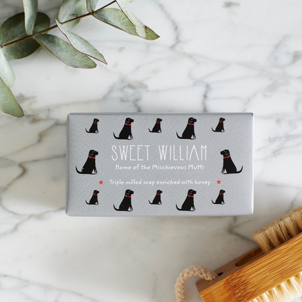 Close-up of Black Labrador soap packaging — Sweet William triple milled soap enriched with honey, featuring an illustrated Black Labrador repeat pattern