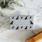 Close-up of Black Cocker Spaniel soap packaging — Sweet William triple milled soap enriched with honey, featuring an illustrated Black Cocker Spaniel repeat pattern
