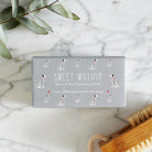 Close-up of Dalmatian soap packaging — Sweet William triple milled soap enriched with honey, illustrated Dalmatian repeat pattern
