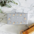 Close-up of Pug soap packaging — Sweet William triple milled soap enriched with honey, illustrated Pug repeat pattern