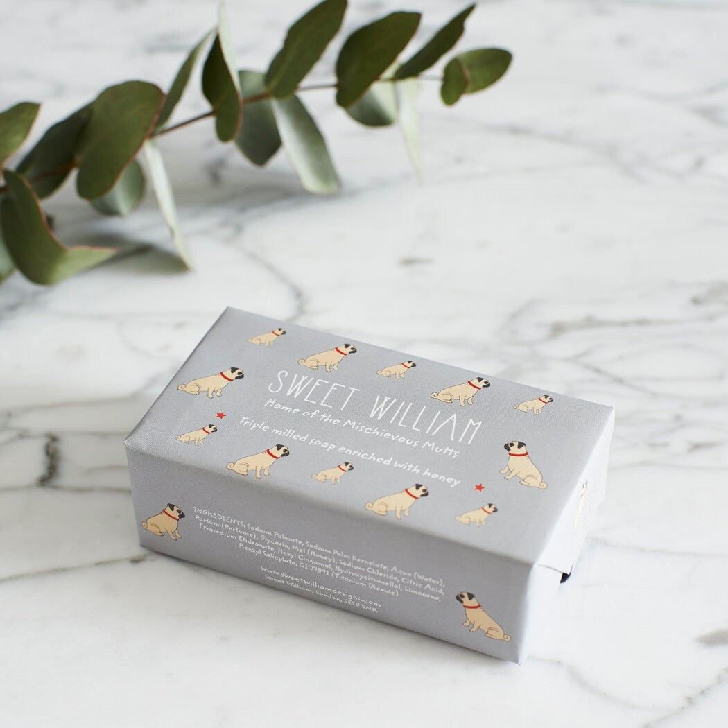 Pug triple milled soap on marble surface — honey-enriched luxury soap in Pug illustrated packaging by Sweet William Designs