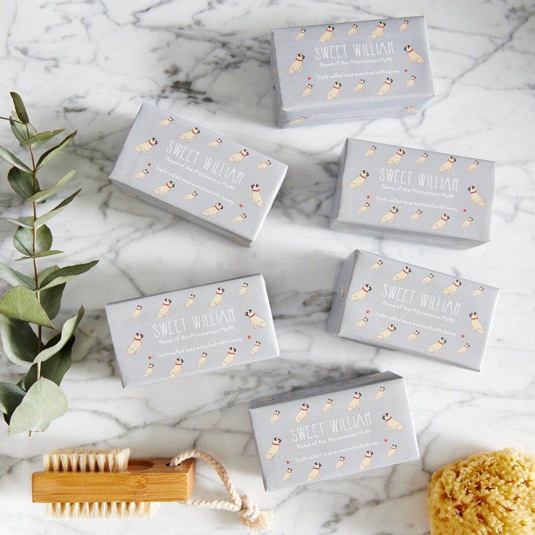 Collection of Pug triple milled soaps on marble surface — honey-enriched luxury dog lover gift by Sweet William Designs