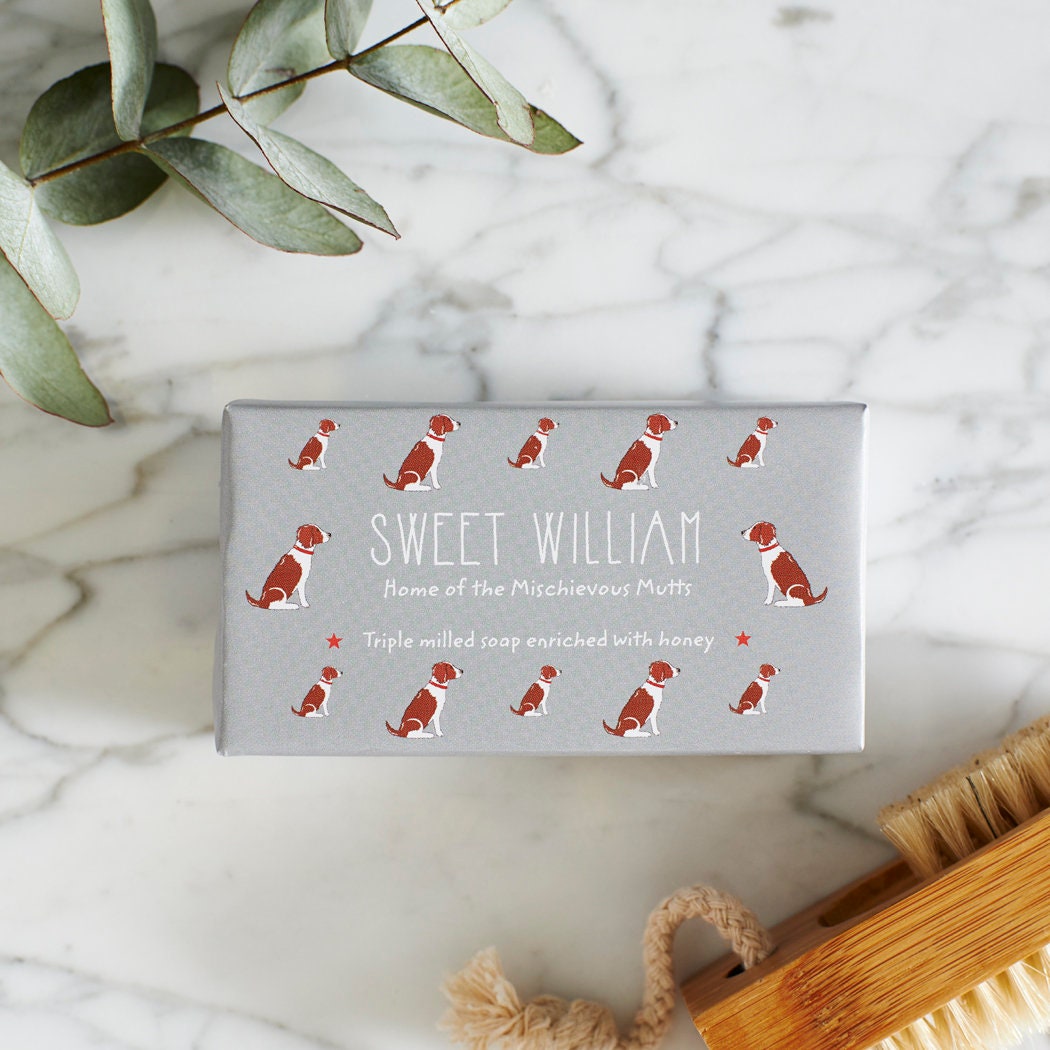 Close-up of Liver & White Springer Spaniel soap packaging — Sweet William triple milled soap enriched with honey, featuring an illustrated Liver & White Springer Spaniel repeat pattern