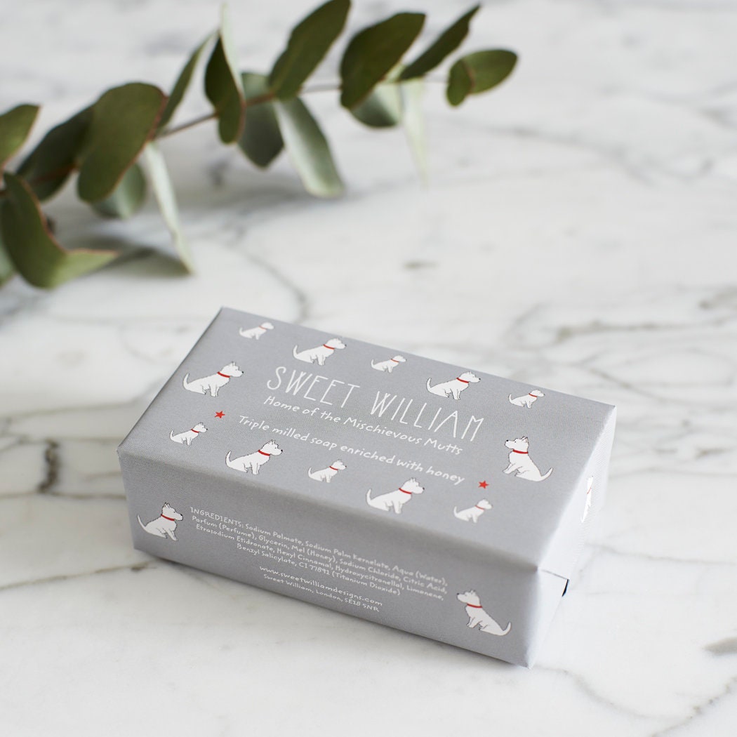 Westie triple milled soap on marble surface — honey-enriched luxury soap in Westie illustrated packaging by Sweet William Designs