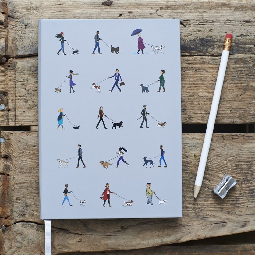 Close-up of Dog Walker's Notebook cover — illustrated dog walkers and dogs on pale grey hardback, A5 lined notebook, dog lover stationery gift