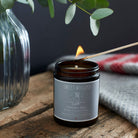 Christmas Dog soy wax candle being lit with a match — orange, cinnamon and clove scented, vegan dog lover gift by Sweet William Designs