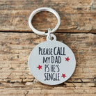 Close-up of 'Please Call My Dad – PS He’s Single' dog tag — silver-plated brass with red star design, personalised dog ID tag by Sweet William Designs 