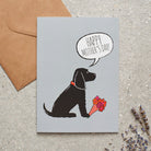 Cocker Spaniel (Black) Mother's Day card featuring illustrated Black Cocker Spaniel holding flowers — blank inside, supplied with kraft envelope, by Sweet William Designs