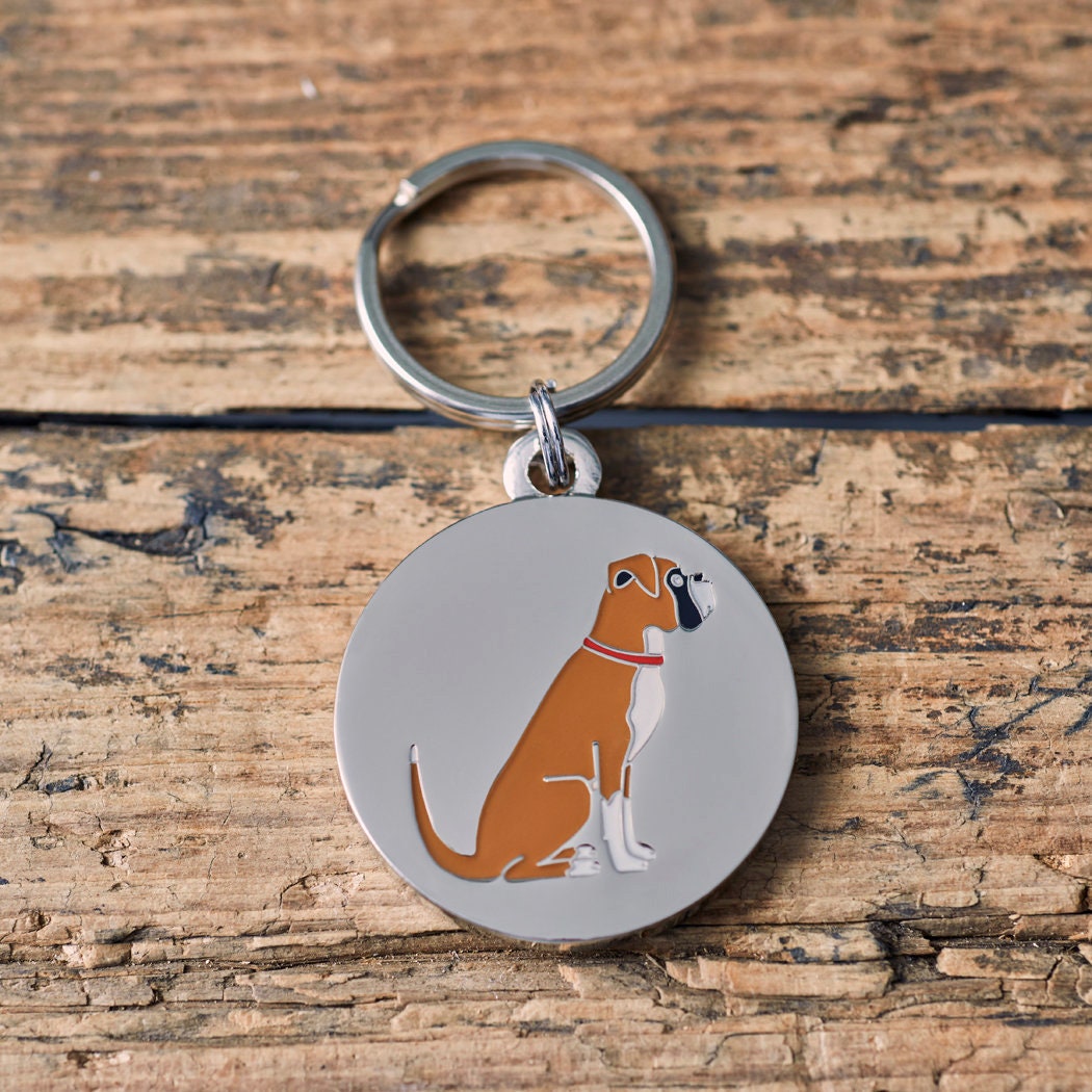 Close-up of Boxer dog ID tag — silver-plated brass with signature Boxer illustration, personalised dog tag by Sweet William Designs