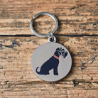Close-up of Black Schnauzer dog ID tag — silver-plated brass with illustrated Schnauzer design, personalised dog tag by Sweet William Designs