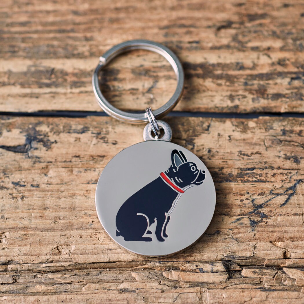 Close-up of French Bulldog dog ID tag — silver-plated brass with illustrated Frenchie design, personalised dog tag by Sweet William Designs
