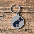 Close-up of French Bulldog dog ID tag — silver-plated brass with illustrated Frenchie design, personalised dog tag by Sweet William Designs