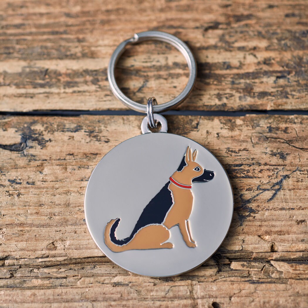 Close-up of German Shepherd dog ID tag — silver-plated brass with illustrated German Shepherd design, personalised dog tag by Sweet William Designs