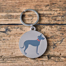 Close-up of Lurcher dog ID tag — silver-plated brass with illustrated Lurcher design, personalised dog tag by Sweet William Designs