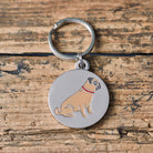 Close-up of Pug dog ID tag — silver-plated brass with illustrated Pug design, personalised dog tag by Sweet William Designs