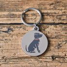 Close-up of Staffordshire Bull Terrier dog ID tag — silver-plated brass with illustrated Staffie design, personalised dog tag by Sweet William Designs