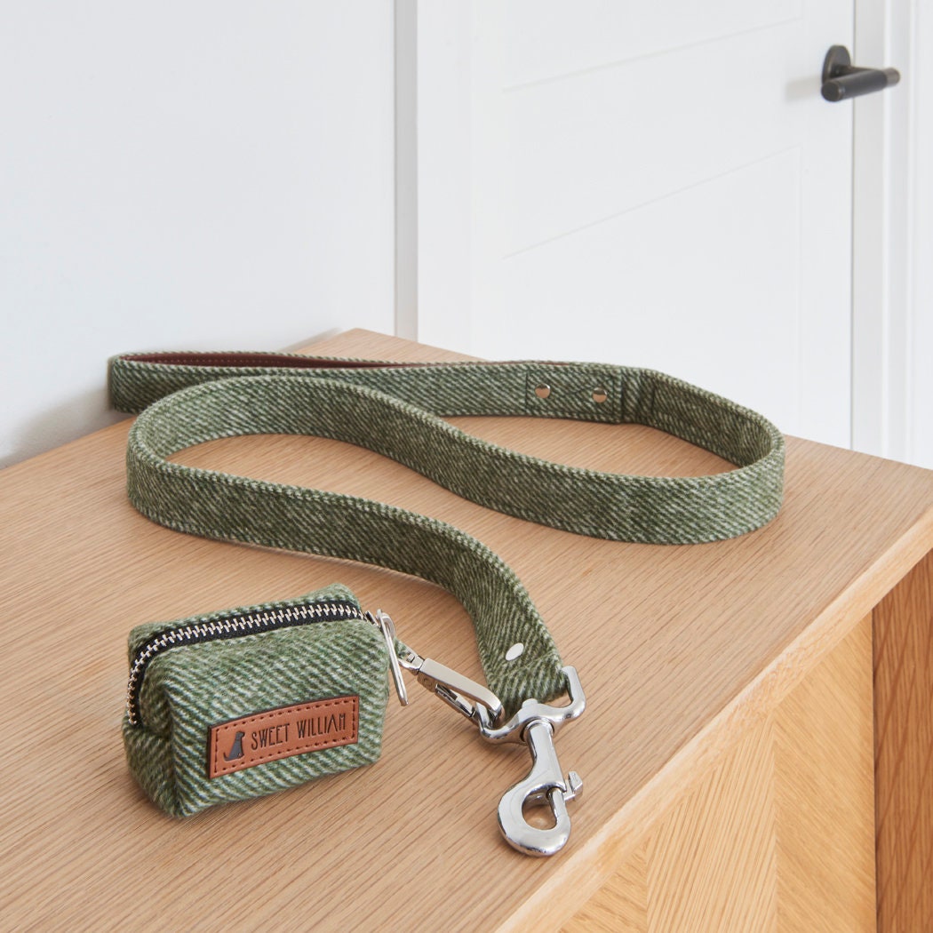 Green tweed poo bag holder beside its matching dog lead, ready for a smart stroll